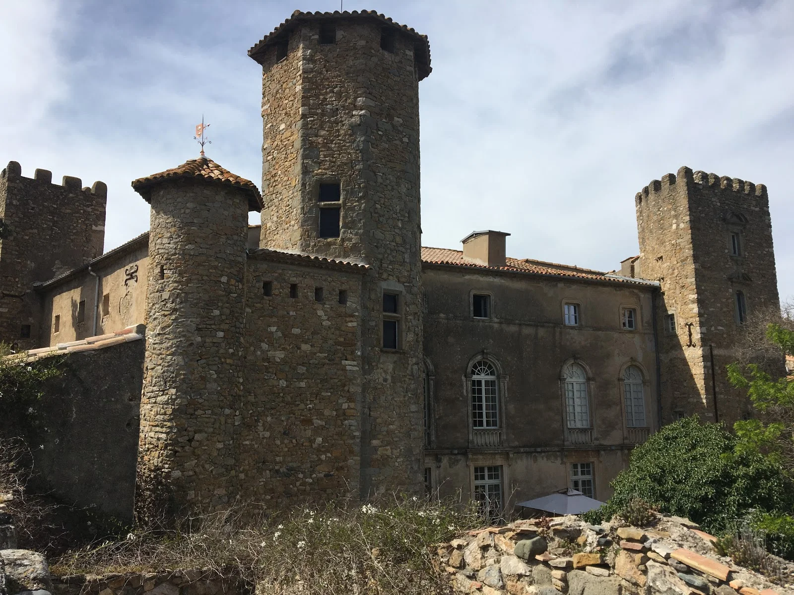 Façade médiévale du Château d'Agel avec tours en pierre et créneaux, lieu de mariage en Hérault