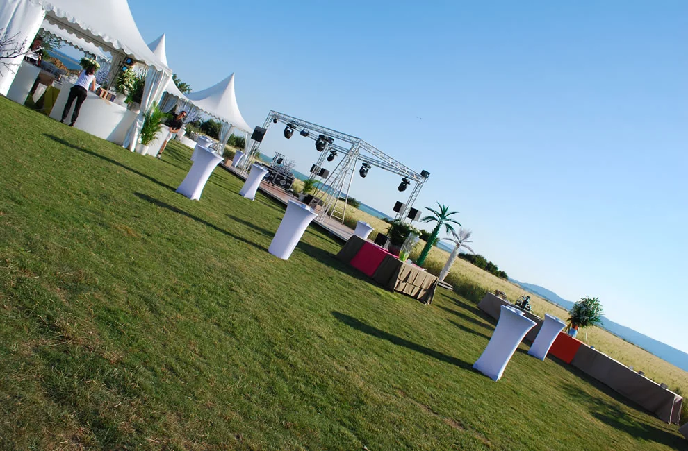 Vue extérieure du Domaine des Moures avec chapiteau blanc et scène événementielle face à l'étang de Thau, Hérault