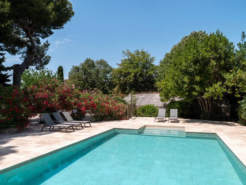 Vue de la piscine et du jardin fleuri du Domaine Fon de Rey, domaine de mariage dans l'Hérault