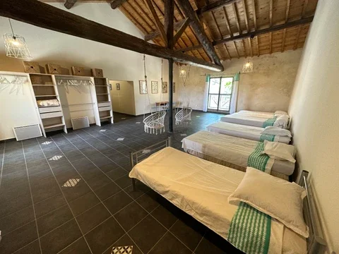 Dortoir avec lits simples et charpente bois au Domaine Les Barrettes Agde, hébergement groupe Hérault