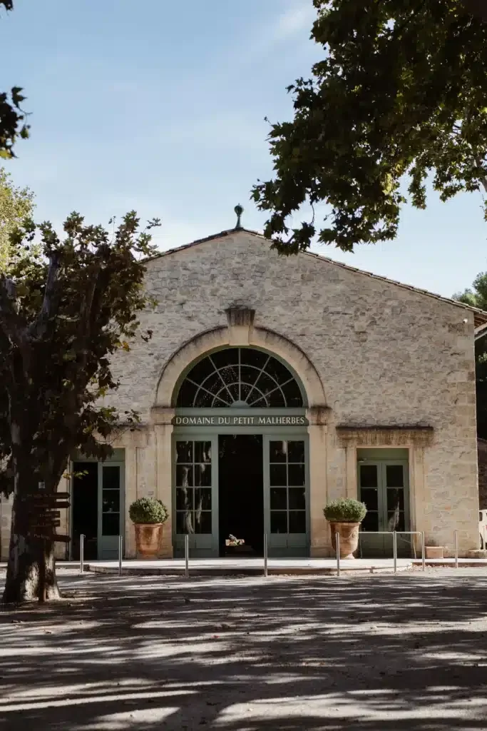 Entrée en pierre du Domaine du Petit Malherbes, domaine de mariage dans l'Hérault avec portail arrondi vert sauge