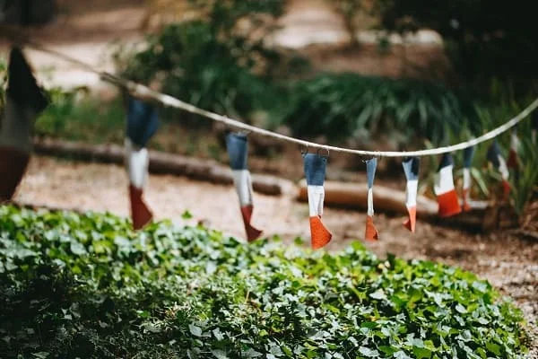 Guirlande de fanions tricolores français dans le jardin du Domaine Saint Hilaire, lieu de mariage en Hérault