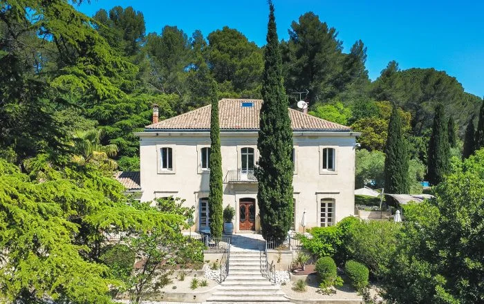 Vue extérieure de La Bastide Castella, domaine de mariage en Hérault entouré de cyprès et de verdure