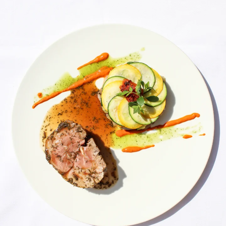 Assiette gastronomique du restaurant Le Grand Arbre Château de Bionne Hérault avec viande aux herbes et tian de courgettes