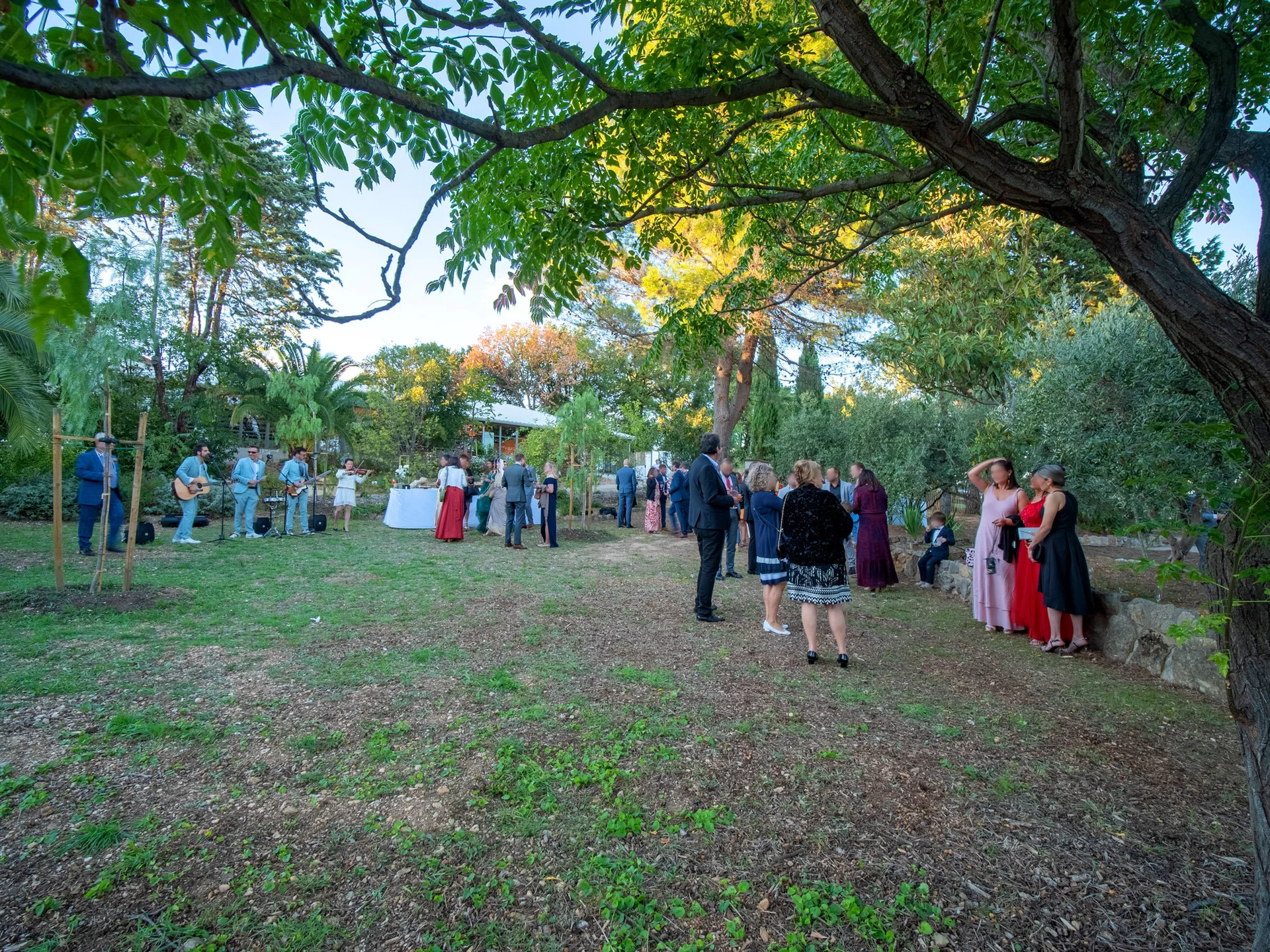 Cocktail de mariage en soirée dans le jardin du Mas Aubrilha en Hérault avec invités élégants et musiciens live