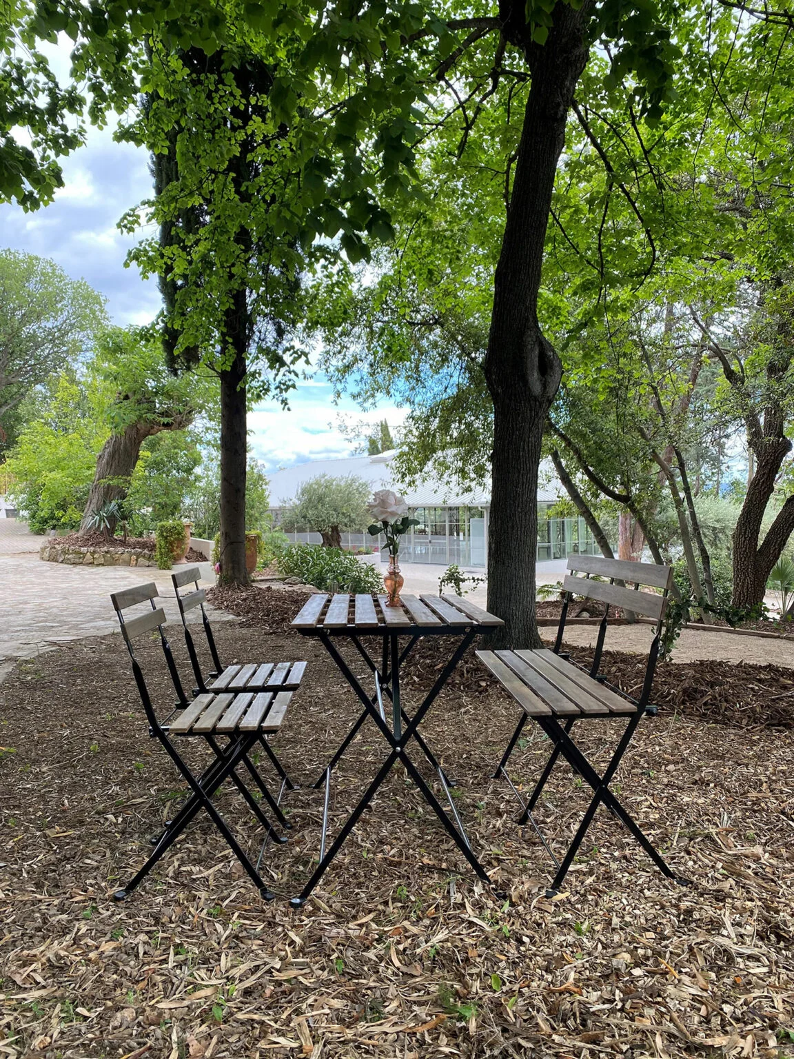Salon de jardin bistrot sous les arbres du Mas Aubrilha, espace détente pour mariage en Hérault