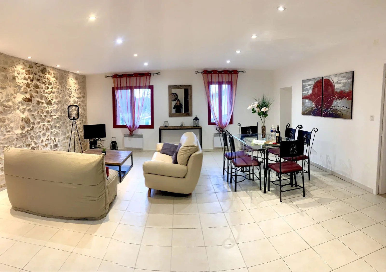 Mas du Pont Hérault - salon salle réception intérieure avec mur en pierres apparentes et rideaux rouges